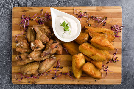 fried chicken wings with potato and dipping sauceの写真素材