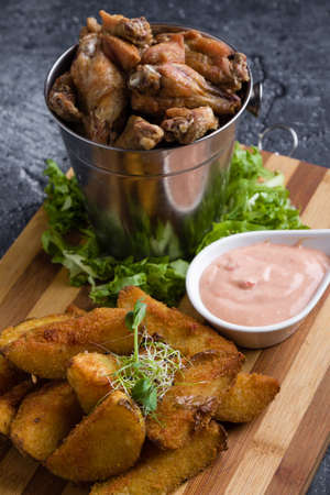 fried chicken wings with potato and dipping sauceの写真素材