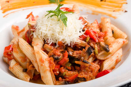 tasty vegetarian penne pasta in white plateの写真素材