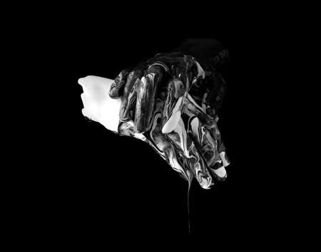 concept image of two hands covered in black and white paint touchingの写真素材