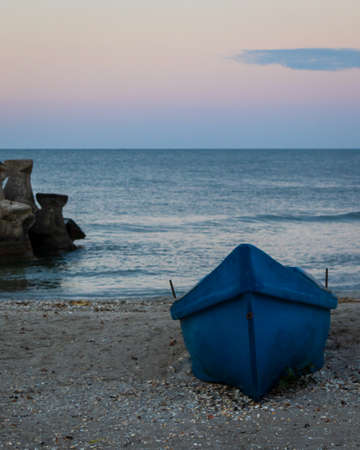 boat on the beach at sunriseの写真素材