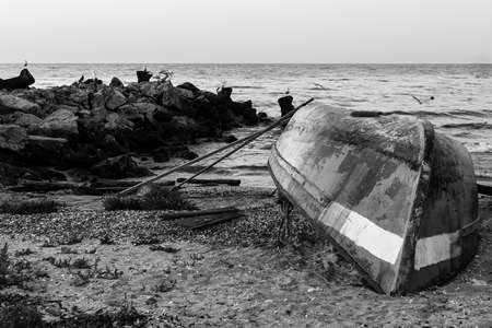 boat on the beach at sunriseの写真素材