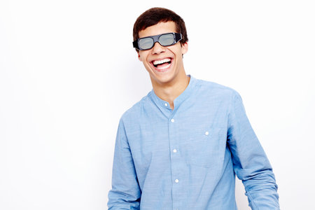 Young hispanic man wearing jeans shirt and 3D TV LCD shutter glasses standing and loudly laughing...