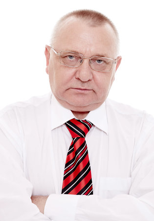 Serious middle aged businessman wearing glasses, red and black striped tie with white shirt standing...