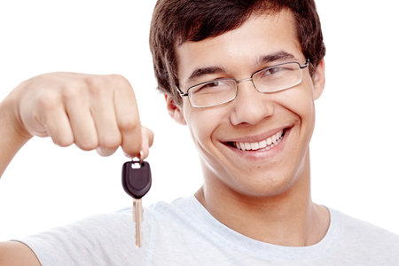 Close up portrait of young hispanic man wearing glasses and blue t-shirt holding out car keys and...