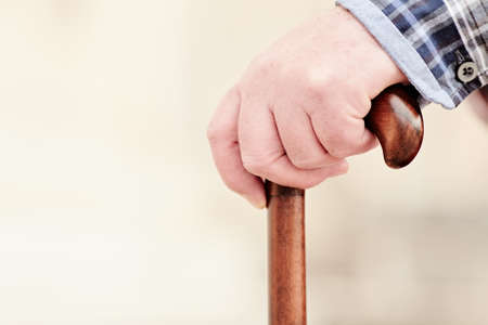 Close up of walking stick in senior male hand outdoors - recovery conceptの写真素材