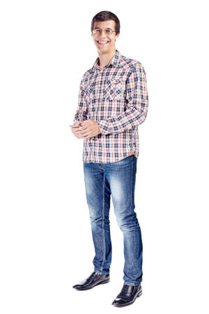 Full body portrait of smiling young man with mobile phone in hands, wearing metal frame glasses, checkered shirt, blue jeans and black shoes isolated on white backgroundの写真素材