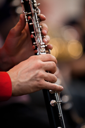 Human hands playing a clarinet closeupの写真素材