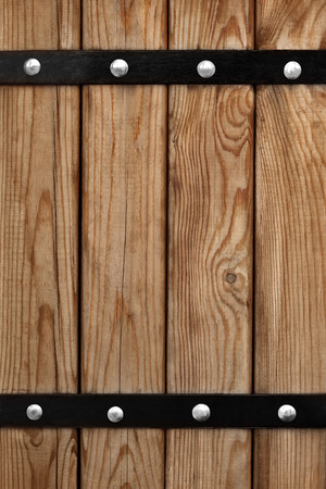 Background of wooden boards with iron mountingsの写真素材