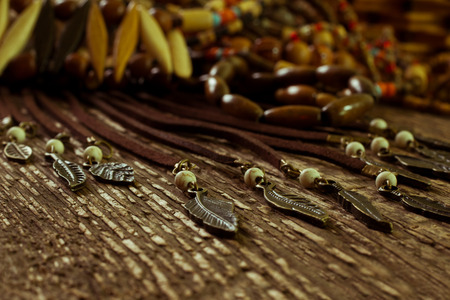 Ethnic jewelry closeup on a wooden surfaceの写真素材