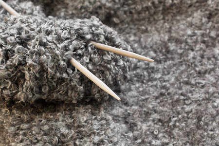Ball of wool with knitting needles closeup