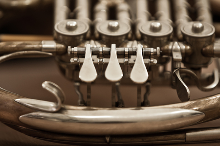 Fragment of a French horn closeup in dark tonesの写真素材