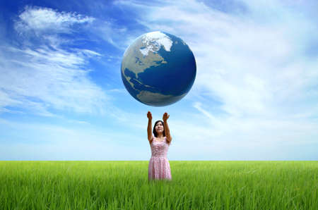 Woman holding the world globe in her hands の写真素材