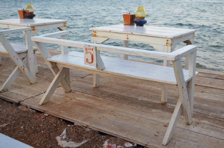 white tables at seaside restaurant with beautiful viewの写真素材