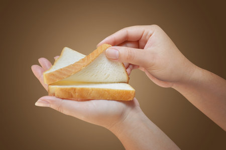 hand holding two slices of bread