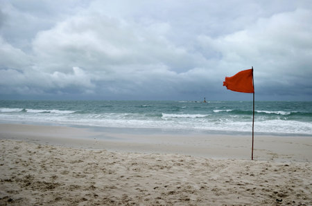 red warning flag on beachの写真素材