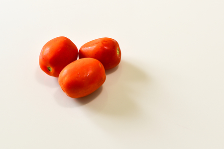 Tomatoes on the white isolated background, raw foodの写真素材