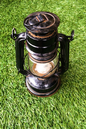 Hurricane lamp , storm lantern isolated on grassの写真素材