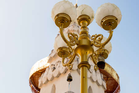 Gold Lamp with bell in the temple (Thailand architecture)の写真素材