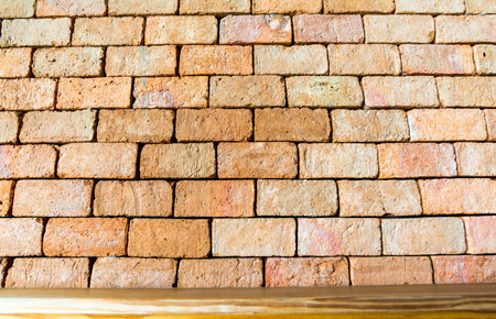 Old orange brick wall on the brown wood, Background retroの写真素材