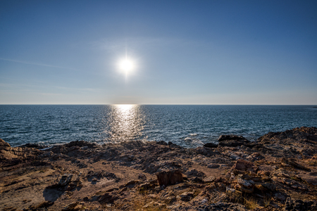 Sun light with shadow on Sea wave behind the rock and sand shore, Khao Leam Ya National Park in Rayong of Thailandの写真素材