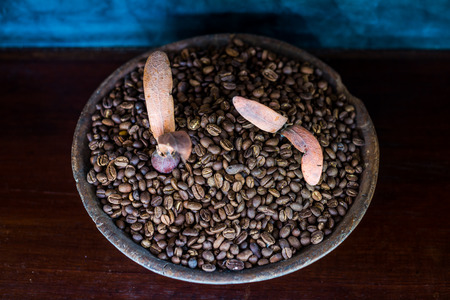 Coffee bean in earthenware jar on wooden table, Cafe in Thailandの写真素材