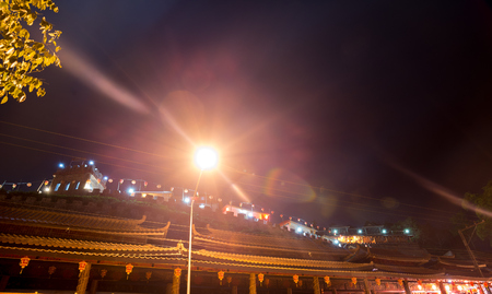 Chinese building in the night with light lamp and flare, Clear sky in the townの写真素材