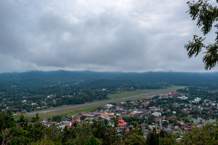 Runway of Airport in Countryside with village and lake in the hill in the cloudy day with soft sunlight, Traveling in Thailandの写真素材