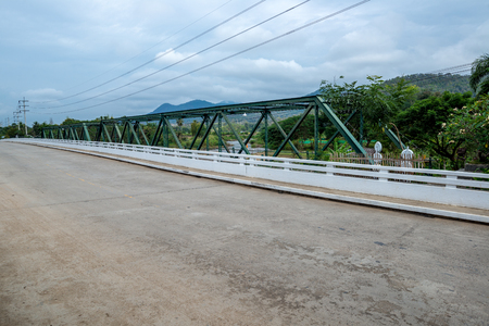 Metal Truss beam bridge with concrete road in countryside hill, Traveling in Thailandの写真素材