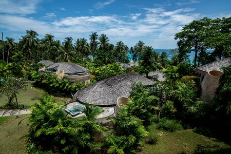 Huts village beside the sea and tropical environment with the cloudy sky, vacation trip