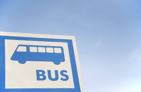 bus stop sign over the blue skyの写真素材