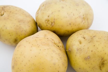 four young potatoes with gentle shadow on natural backgroundの写真素材