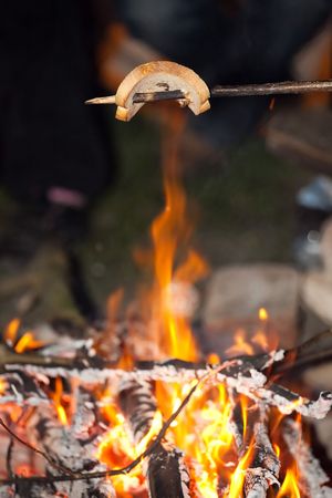 crispy bread over fireplace - typical camping sceneの写真素材