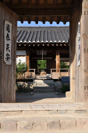 open gate to traditional hanok courtyard in hahoe folk village, andong, south koreaの写真素材