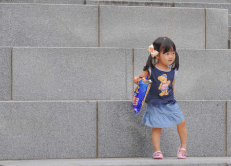 SEOUL, SOUTH KOREA - AUGUST 2012 - Ewha Womans University little girl playing on steps of Campus Complex (ECC) building.のeditorial素材