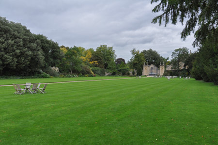 View of folding chairs & english lawn from Trinity College Garden Quad, Oxford, United Kingdom. Overcast Sky.のeditorial素材