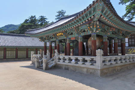 Korean buddhist temple from Silla Dynasty era. Bell Pavilion with traditional gong, bell and drum. Translation: "The Sea Seal Bell". Haeinsa Temple, Mount Gaya, Gayasan National Park, South Korea.のeditorial素材