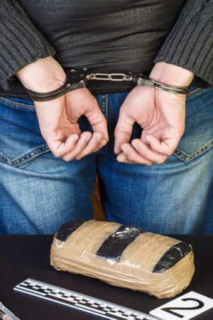 The man in handcuffs was detained for drugs. A crime.の写真素材