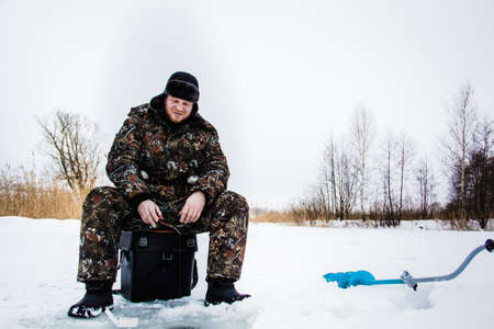 Ice fisherman  on winter lake