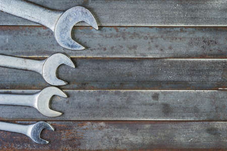 Wrenches on an old rusty metal background.の写真素材