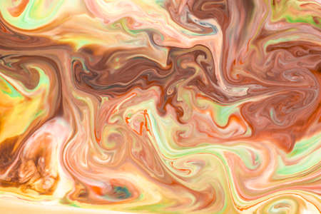 Artistic abstract design created with mixing color liquids. Colorful background texture. Liquids mixing on water surface.の写真素材