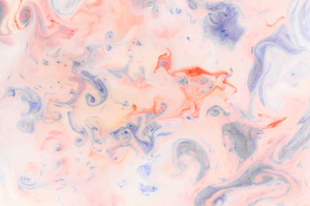 Artistic abstract design created with mixing color liquids. Colorful background texture. Liquids mixing on water surface.の写真素材