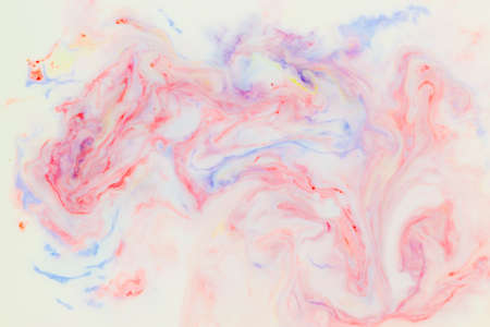 Artistic abstract design created with mixing color liquids. Colorful background texture. Liquids mixing on water surface.の写真素材