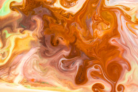 Artistic abstract design created with mixing color liquids. Colorful background texture. Liquids mixing on water surface.の写真素材