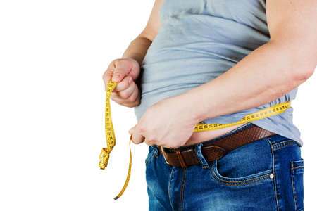 The belly of a fat man isolated on white background. Fat man holding a measuring tape. Weight Loss.の写真素材