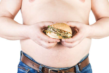 Thick mature man holding a hamburger hand, isolated on white background.の写真素材
