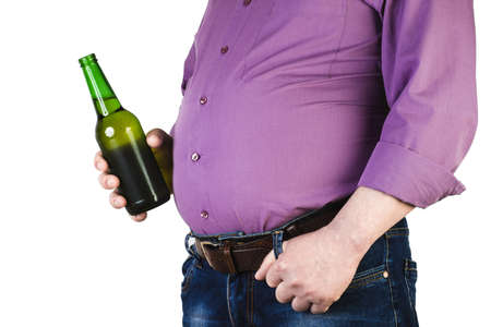 A man with a big belly, with a bottle of beer.の写真素材