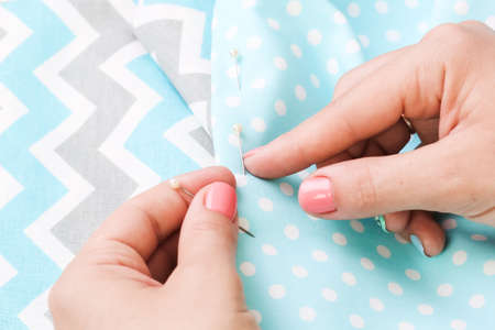 Hands of a girl with a needle and cloth. Handmade. Women's hobby. Scrapbooking Diy.の写真素材