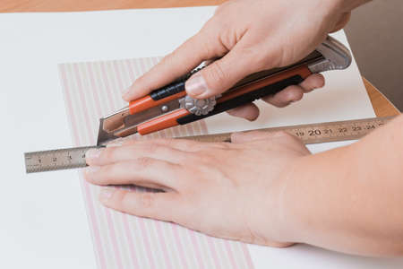 Girl's hand cut paper, scrapbooking for wedding or other festive decorations .の写真素材