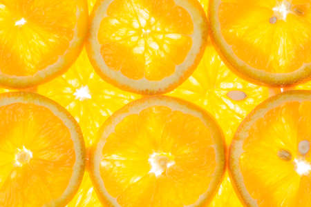 bright orange background of slices of juicy oranges, background imageの写真素材